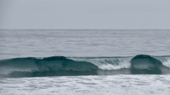 wake breaking in a glassy surf morning in Ecuador